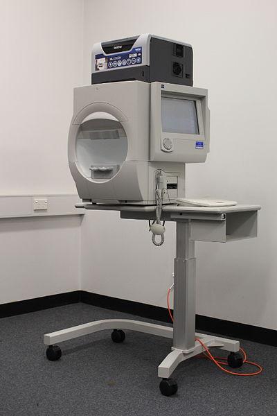 A cutting-edge machine for eye health and care is sitting on a table in a room.